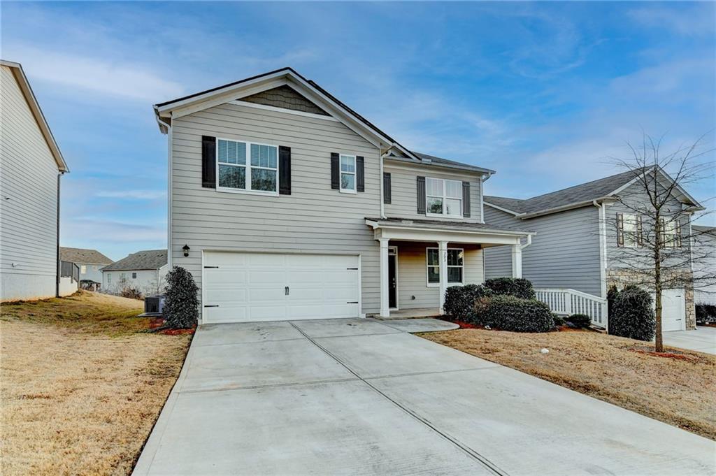 393 Walnut Grv Way Pendergrass, GA 30567 - Photo 2 of 45 a front view of a house with a yard