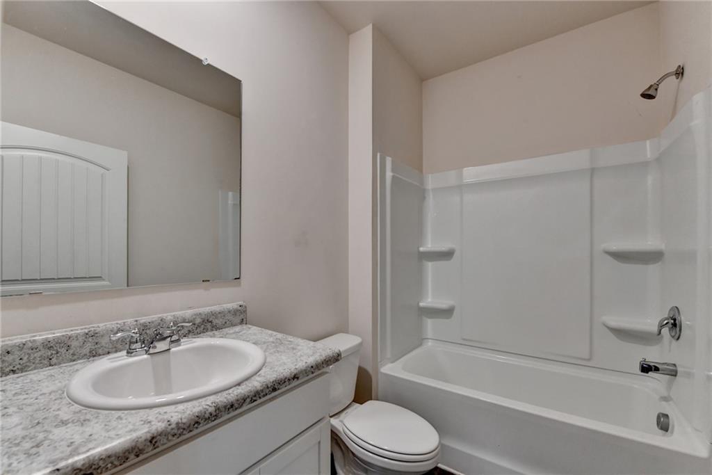 393 Walnut Grv Way Pendergrass, GA 30567 - Photo 22 of 45 a bathroom with a granite countertop sink toilet and shower