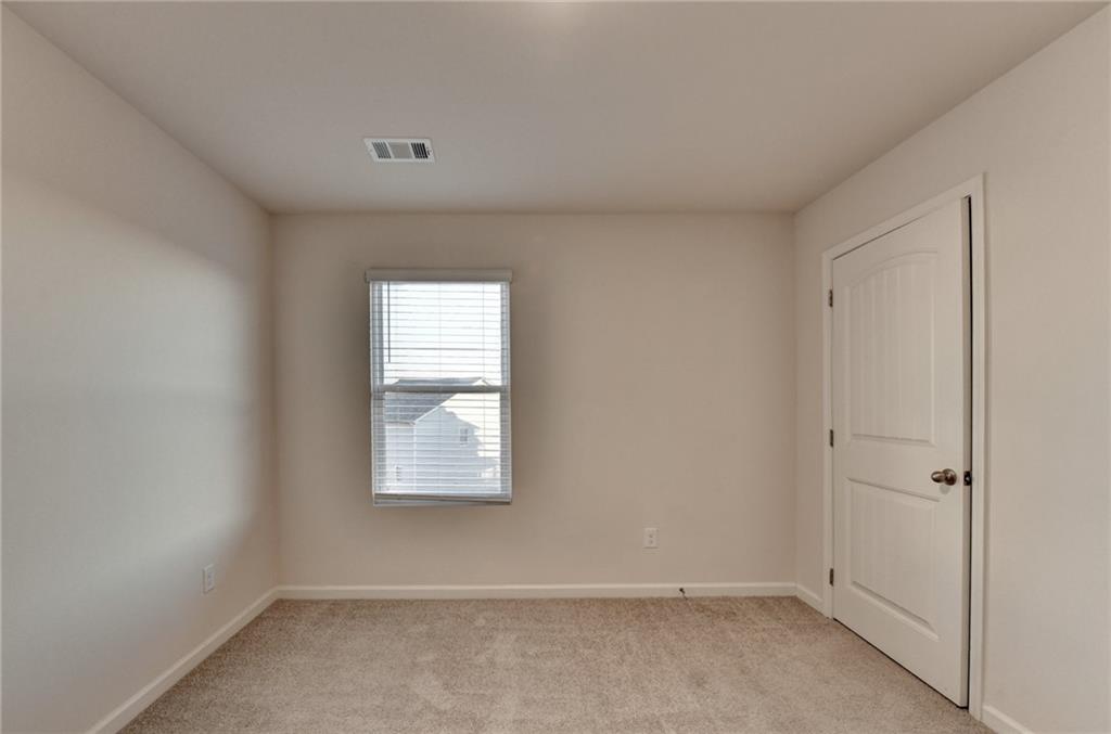 393 Walnut Grv Way Pendergrass, GA 30567 - Photo 26 of 45 an empty room with windows