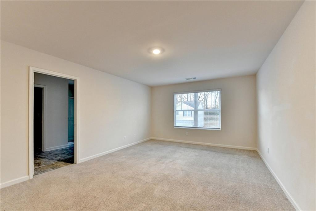 393 Walnut Grv Way Pendergrass, GA 30567 - Photo 29 of 45 an empty room with a empty space and windows