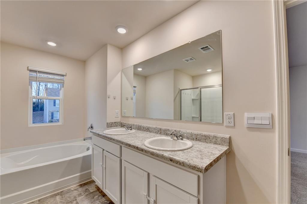 393 Walnut Grv Way Pendergrass, GA 30567 - Photo 32 of 45 a bathroom with a granite countertop sink and a mirror