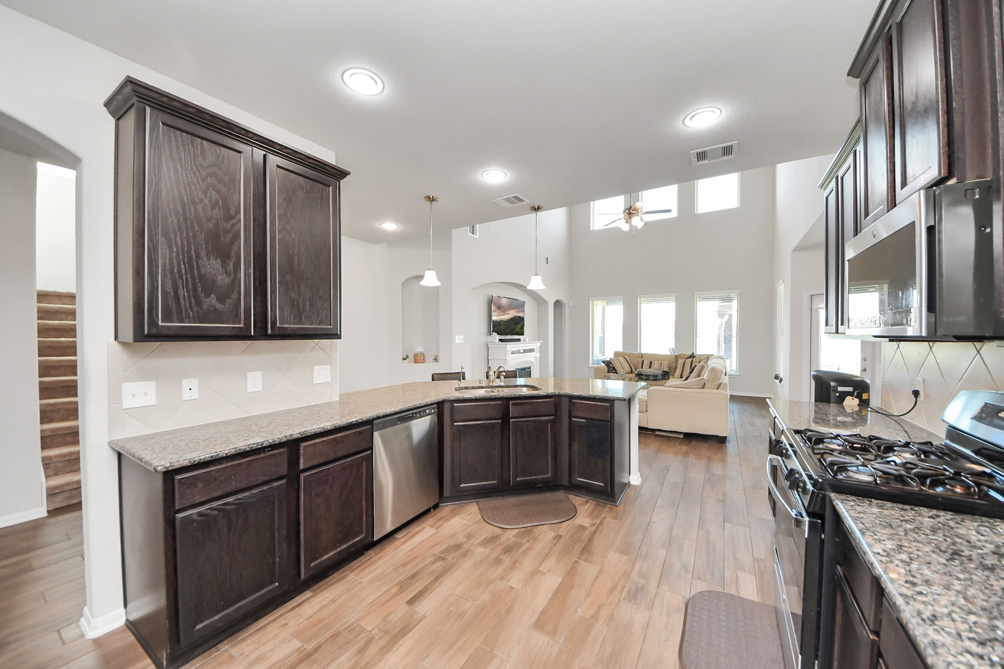 14611 Sycamore Side Way Cypress, TX 77429 - Photo 11 of 46 a large kitchen with stainless steel appliances granite countertop a lot of counter space and a wooden floors