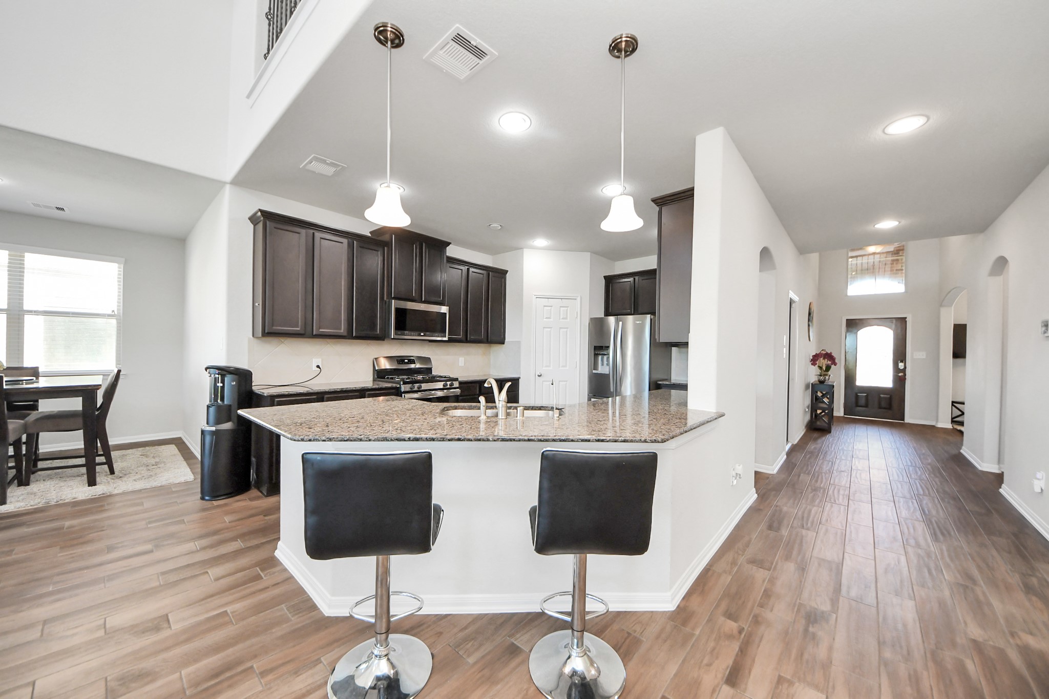 14611 Sycamore Side Way Cypress, TX 77429 - Photo 15 of 46 a large kitchen with stainless steel appliances kitchen island granite countertop a large island in the center