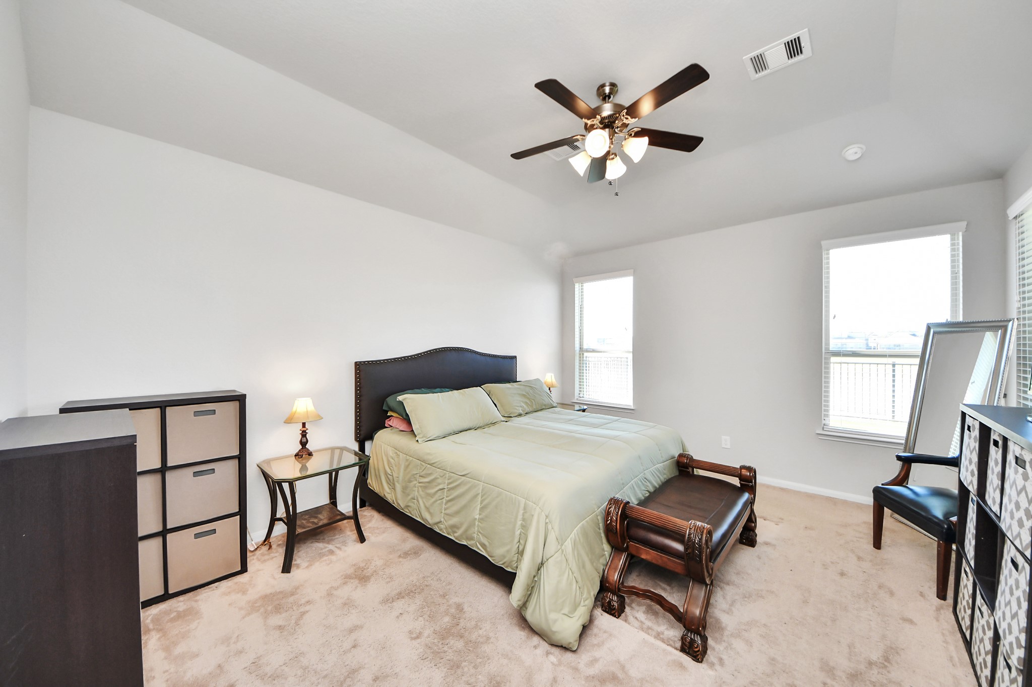 14611 Sycamore Side Way Cypress, TX 77429 - Photo 22 of 46 a bedroom with a bed and a chandelier