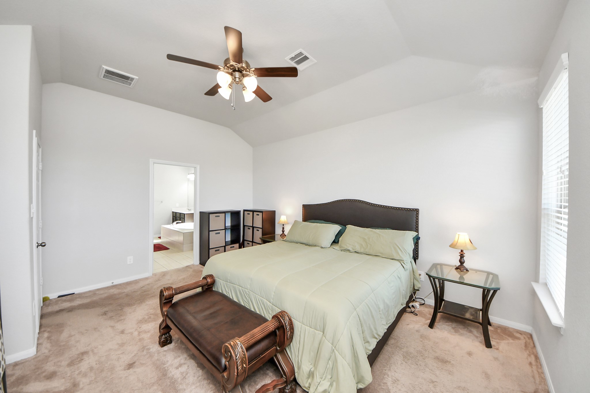 14611 Sycamore Side Way Cypress, TX 77429 - Photo 23 of 46 a bedroom with a bed and a chandelier