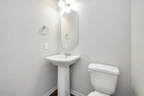 a large kitchen with stainless steel appliances granite countertop a stove refrigerator and sink