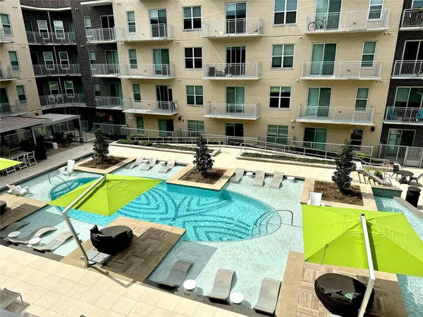 a view of a swimming pool with outdoor seating