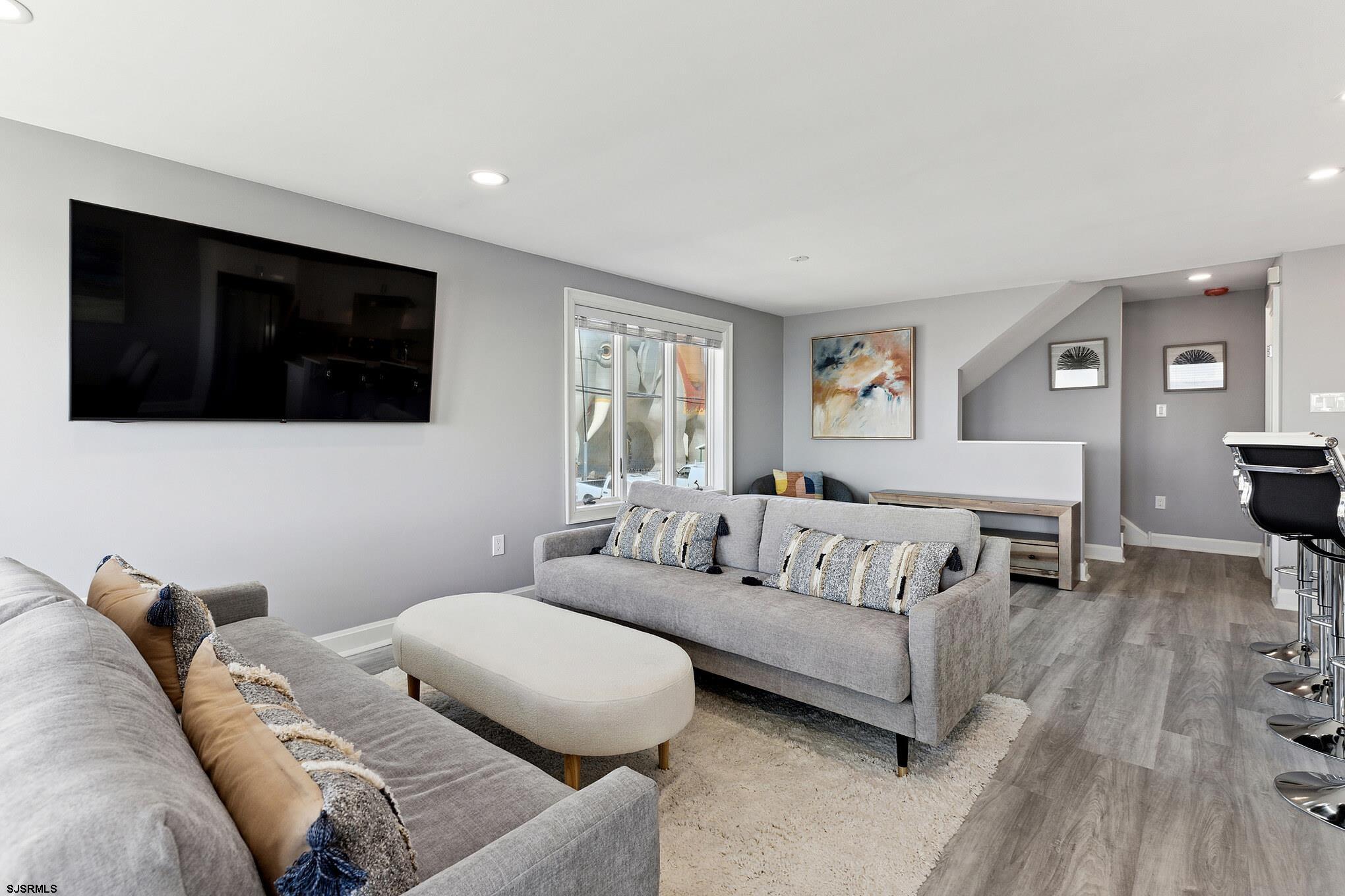 111 South Decatur Avenue Margate City, NJ 08402 - Photo 17 of 39 a living room with furniture and a flat screen tv