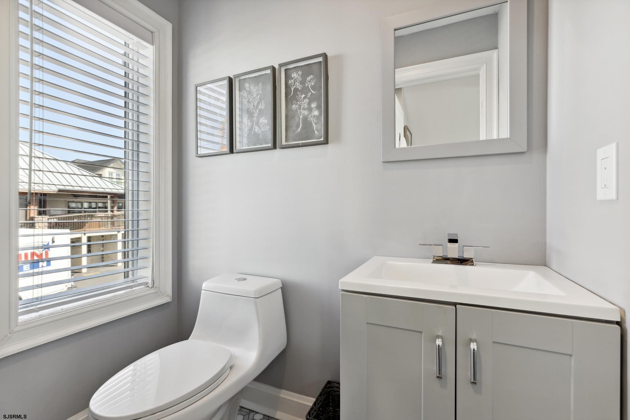 111 South Decatur Avenue Margate City, NJ 08402 - Photo 21 of 39 a bathroom with a toilet sink and mirror
