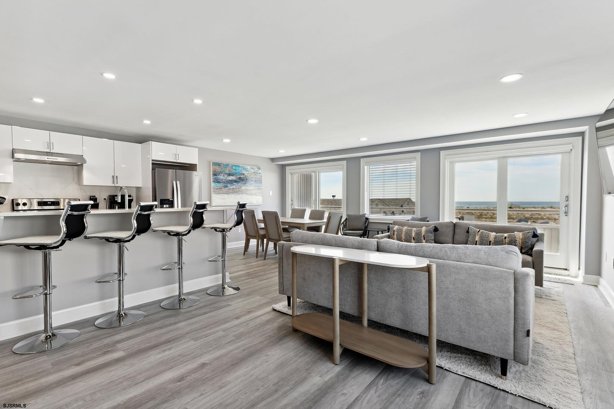 111 South Decatur Avenue Margate City, NJ 08402 - Photo 5 of 39 a living room with stainless steel appliances kitchen island granite countertop furniture and a large window
