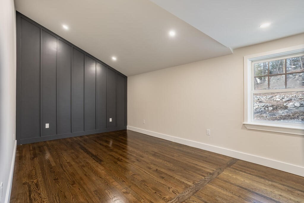 79 Bonham Road Dedham, MA 02026 - Photo 13 of 28 a view of an empty room with wooden floor and a window