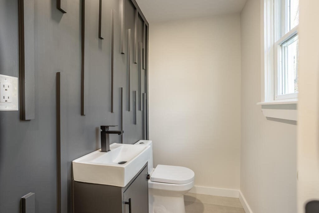 79 Bonham Road Dedham, MA 02026 - Photo 10 of 28 a bathroom with a toilet sink and mirror