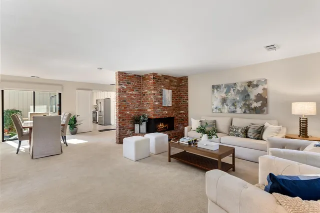 a living room with furniture and fireplace