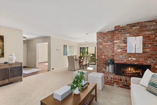 a living room with furniture a fireplace and a table