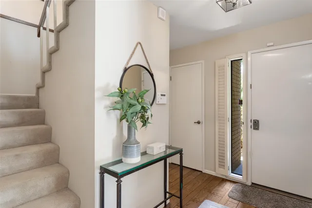 a view of entryway with paintings on the wall