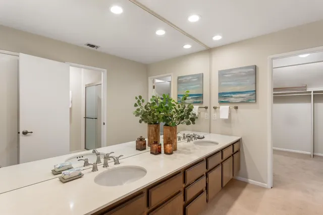 a bathroom with a double vanity sink and a mirror