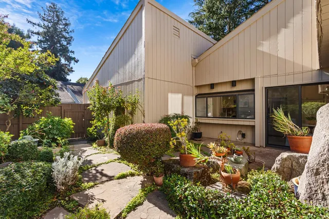 a front view of a house with garden