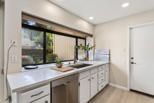 a kitchen with sink and window