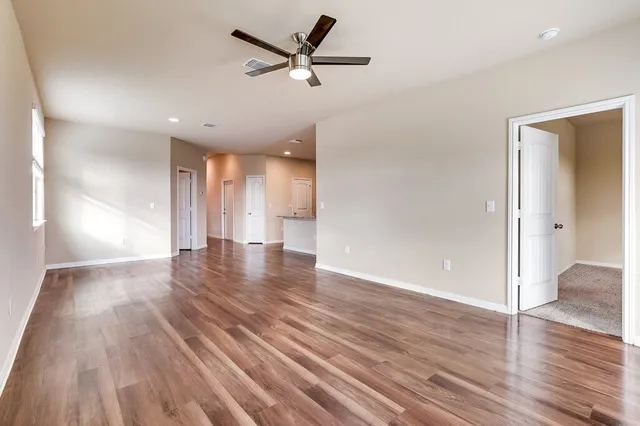 wooden floor in an empty room with a window