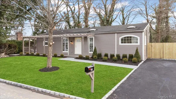 a front view of house with yard and green space
