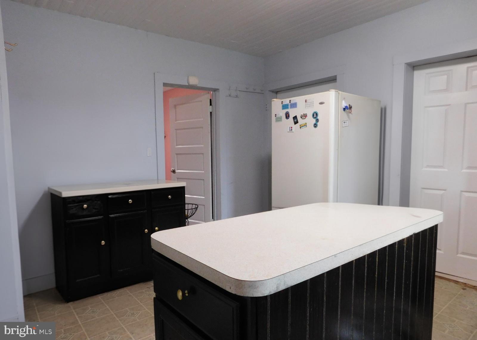 38777 Holmes Mill Road Hamilton, VA 20158 - Photo 11 of 14 a kitchen with a wooden floor and white cabinets