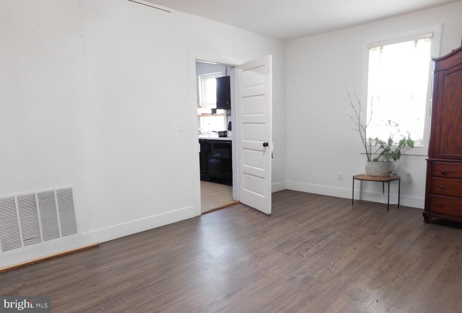 38777 Holmes Mill Road Hamilton, VA 20158 - Photo 3 of 14 a view of an empty room with a window and wooden floor