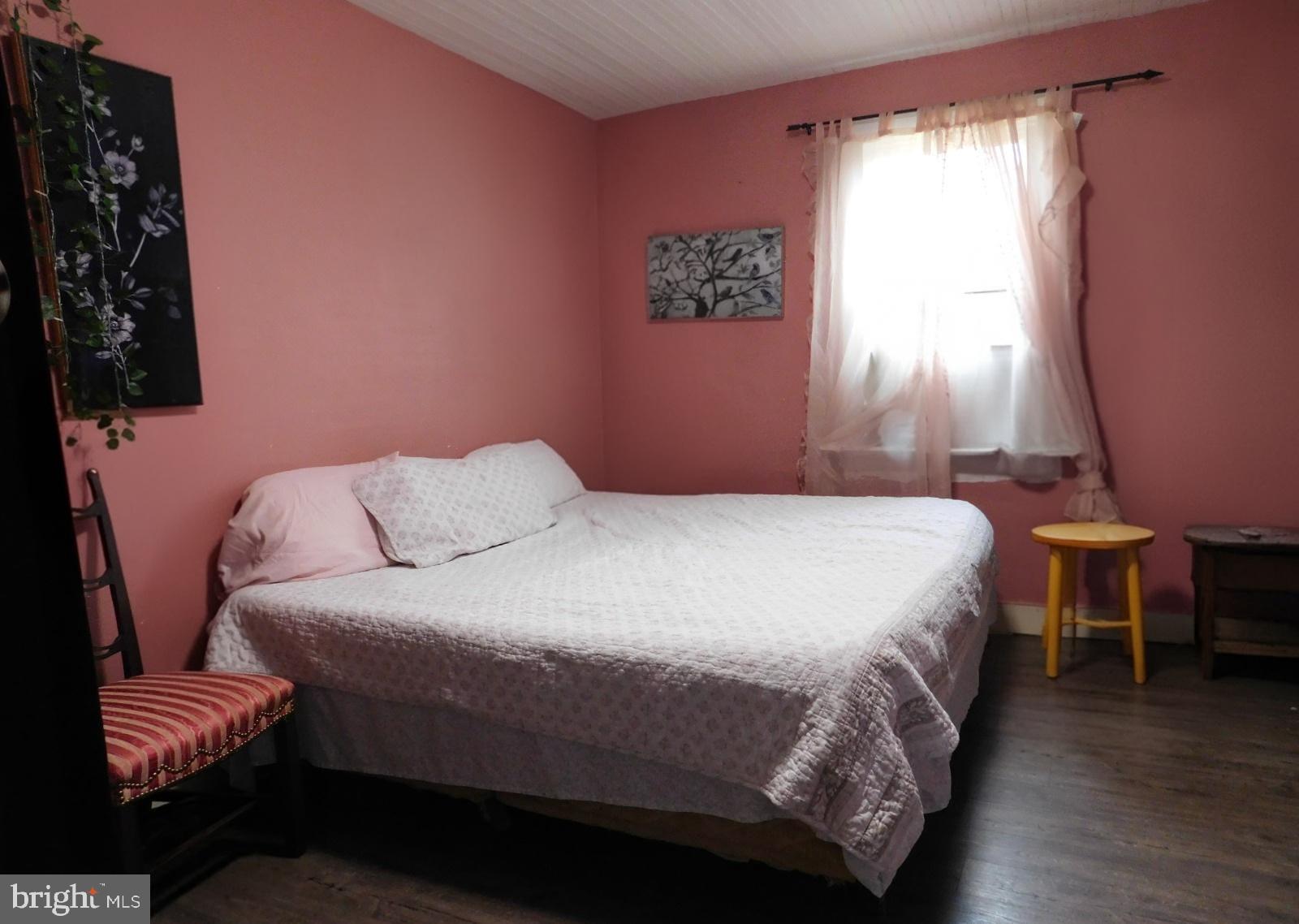 38777 Holmes Mill Road Hamilton, VA 20158 - Photo 7 of 14 a bedroom with a bed and a chair with the potted plant