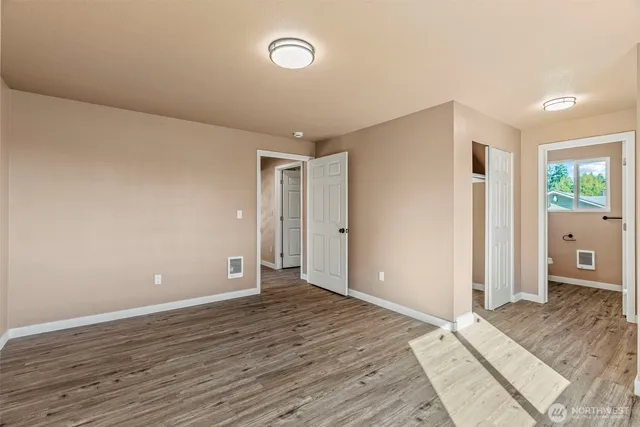 a view of room with window and wooden floor
