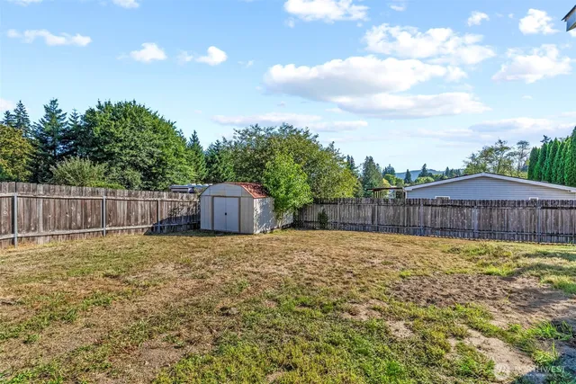 a bathroom with a sink and a yard with wooden fence