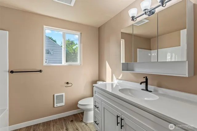 a bathroom with a sink a toilet and a mirror