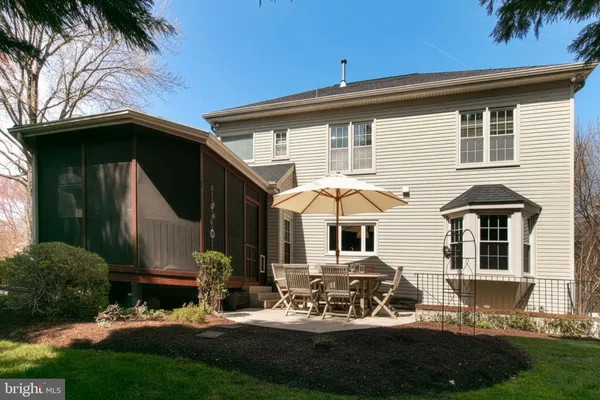 a view of a house with backyard porch and sitting area