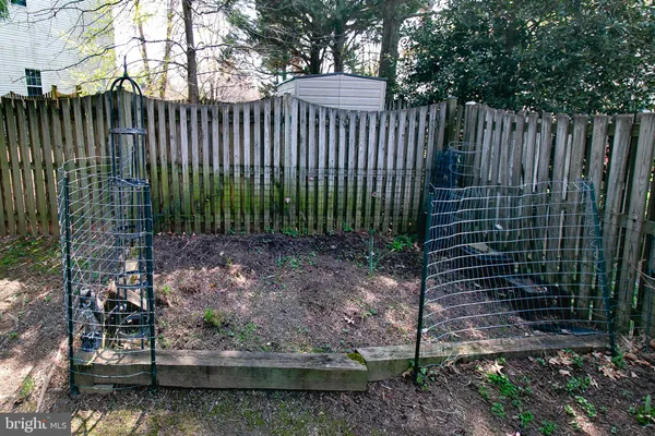 a view of a garden with wooden fence