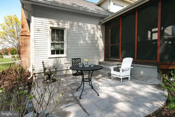 a view of a patio with table and chairs and potted plants