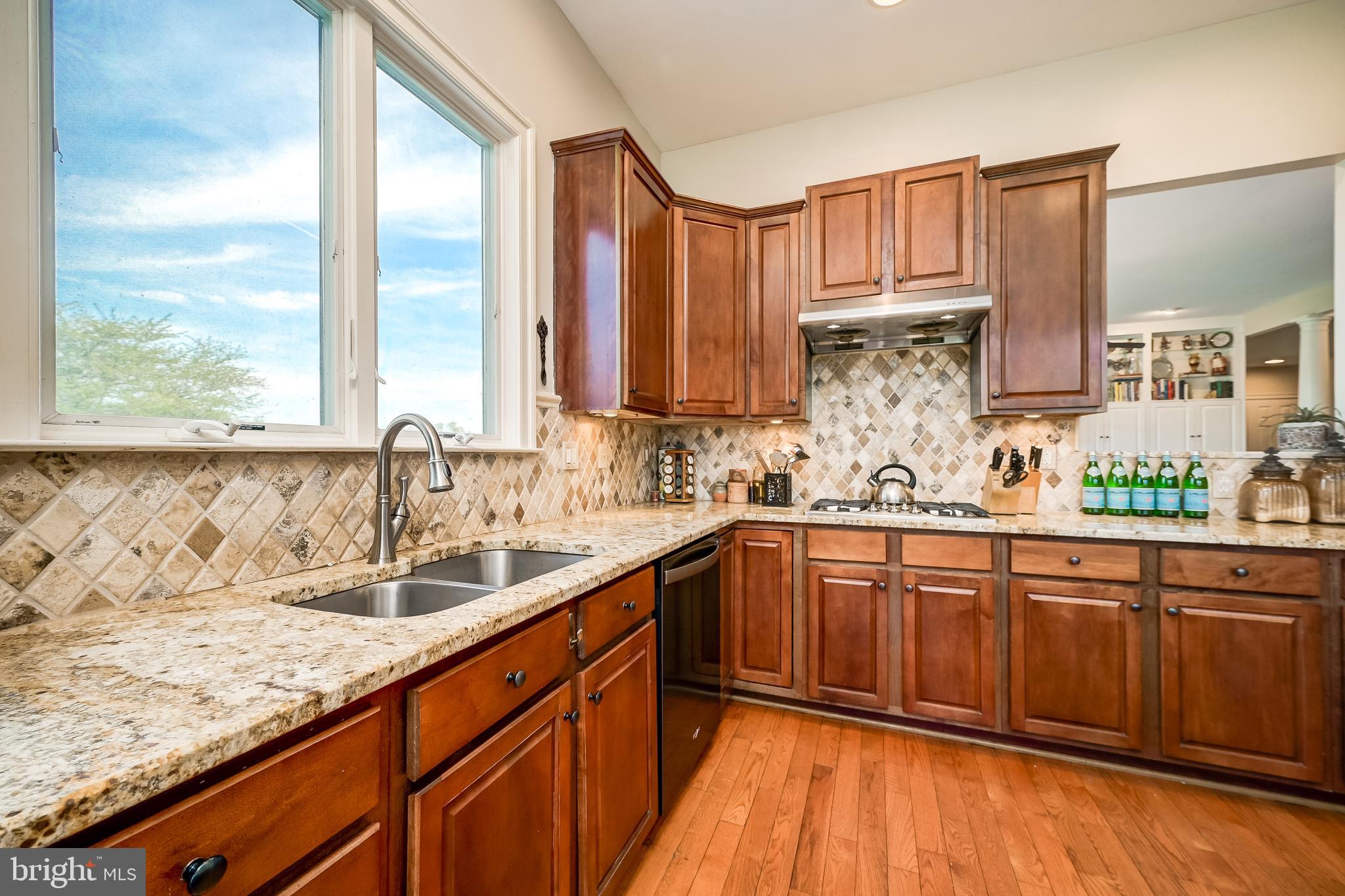 12850 Highland Road Highland, MD 20777 - Photo 15 of 56 a kitchen with stainless steel appliances granite countertop wooden cabinets a sink and dishwasher with wooden floor