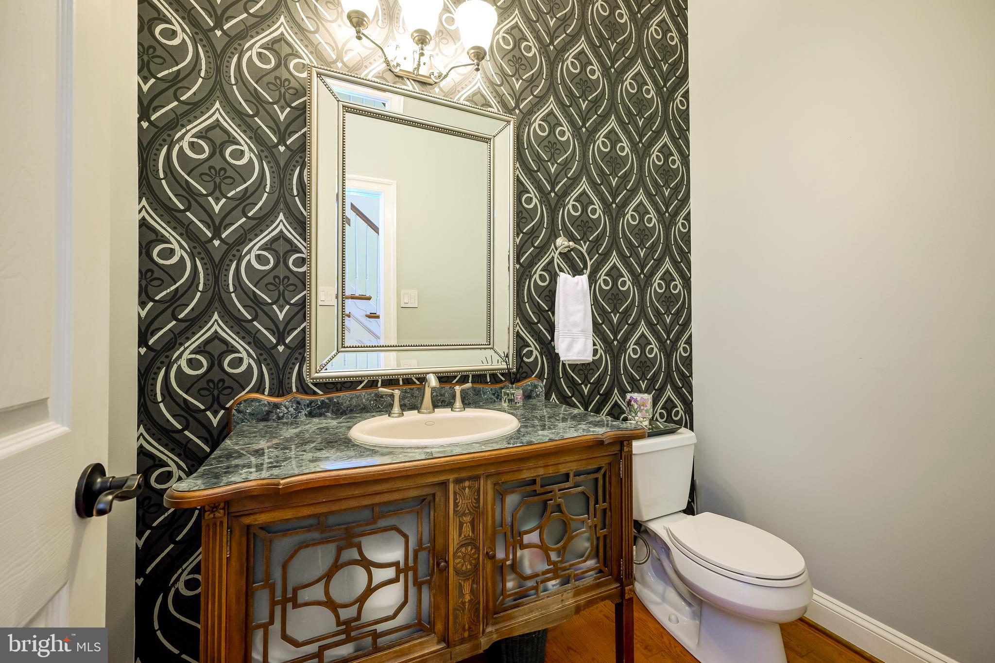 12850 Highland Road Highland, MD 20777 - Photo 23 of 56 a bathroom with a sink a toilet and mirror