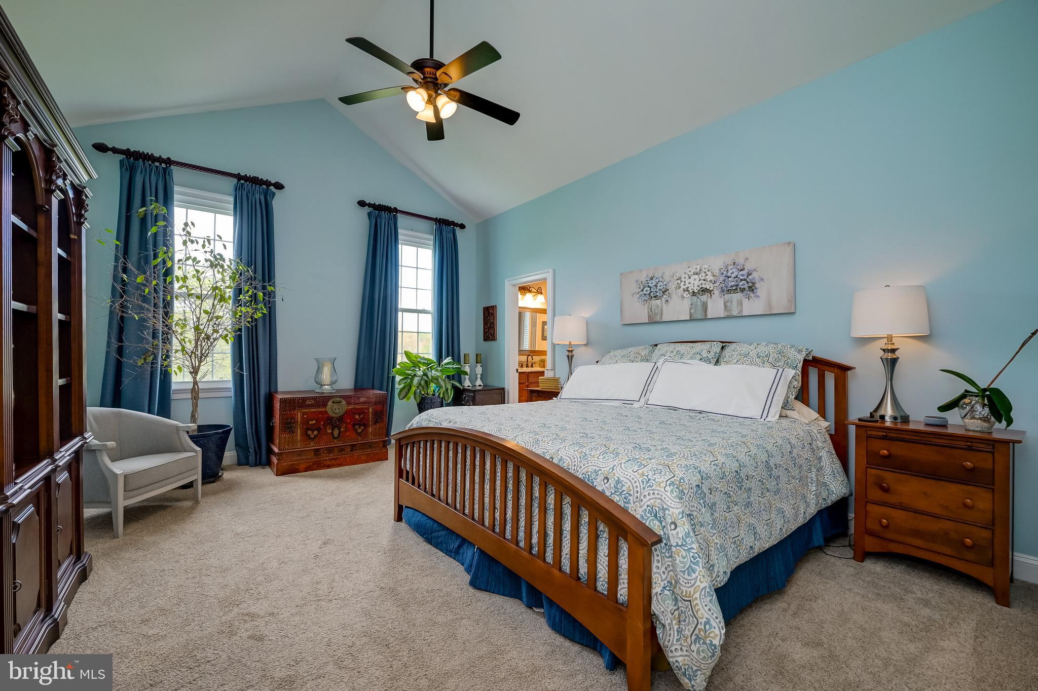 12850 Highland Road Highland, MD 20777 - Photo 25 of 56 a bedroom with a bed and a chandelier