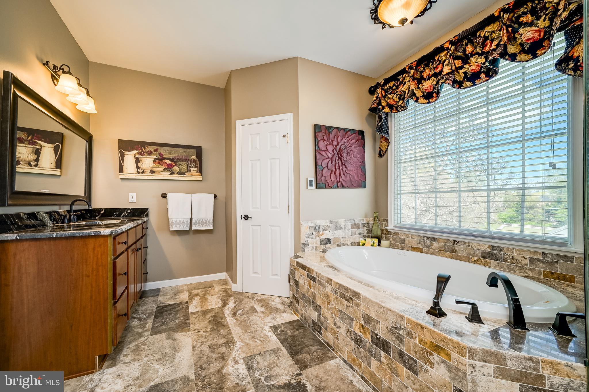 12850 Highland Road Highland, MD 20777 - Photo 34 of 56 a spacious bathroom with sink a bathtub and next to a window