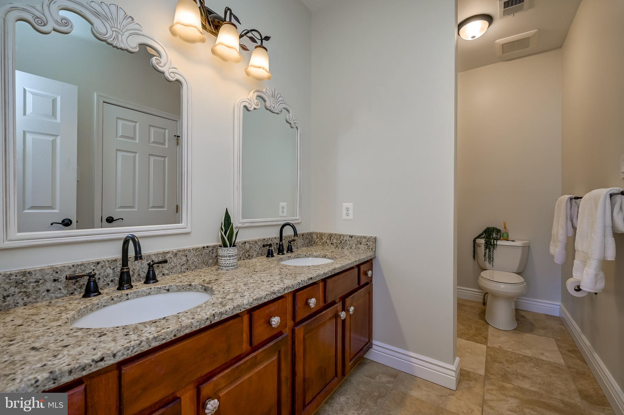 12850 Highland Road Highland, MD 20777 - Photo 38 of 56 a bathroom with a granite countertop sink and a toilet