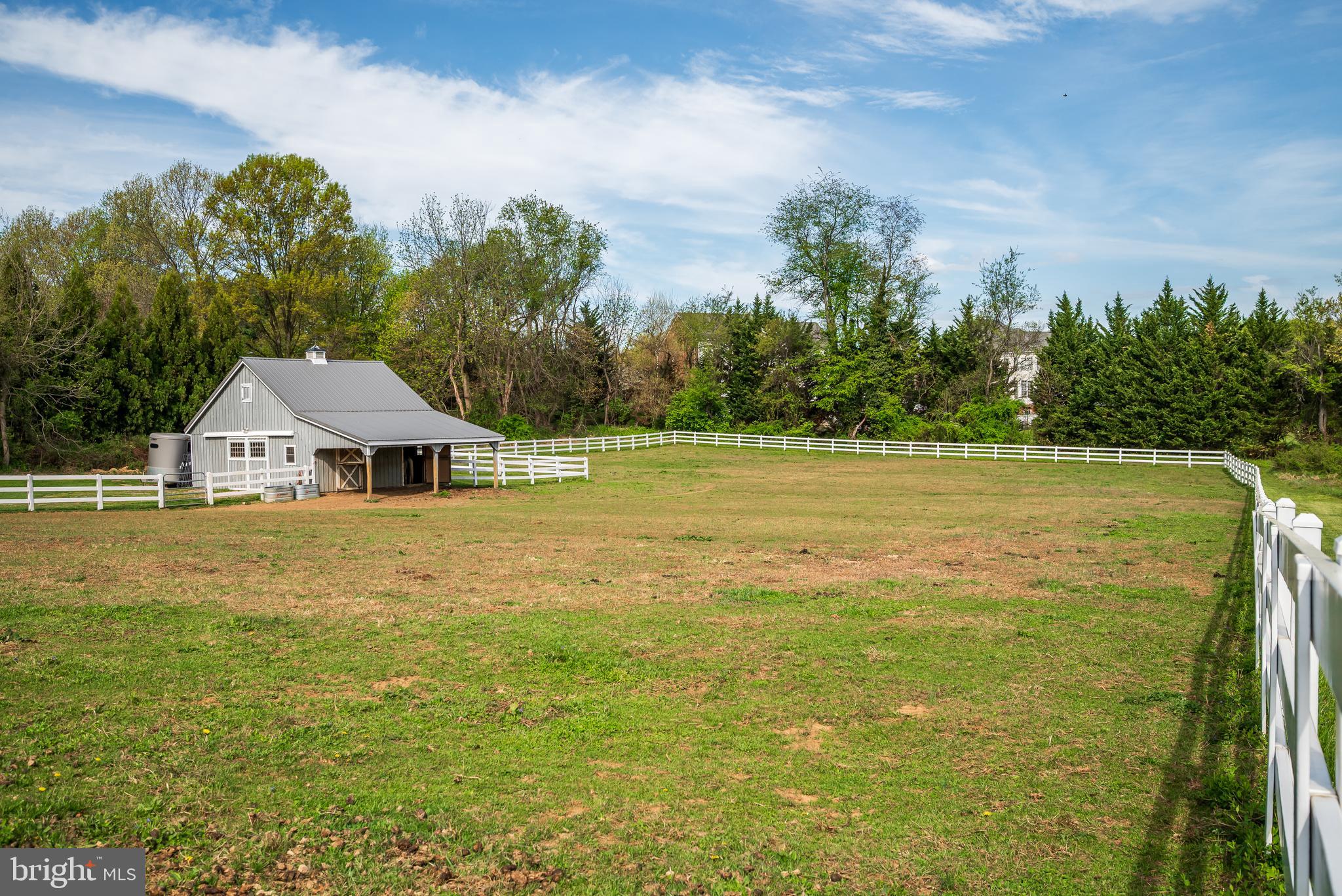 12850 Highland Road Highland, MD 20777 - Photo 54 of 56 a white house with a big yard and large trees