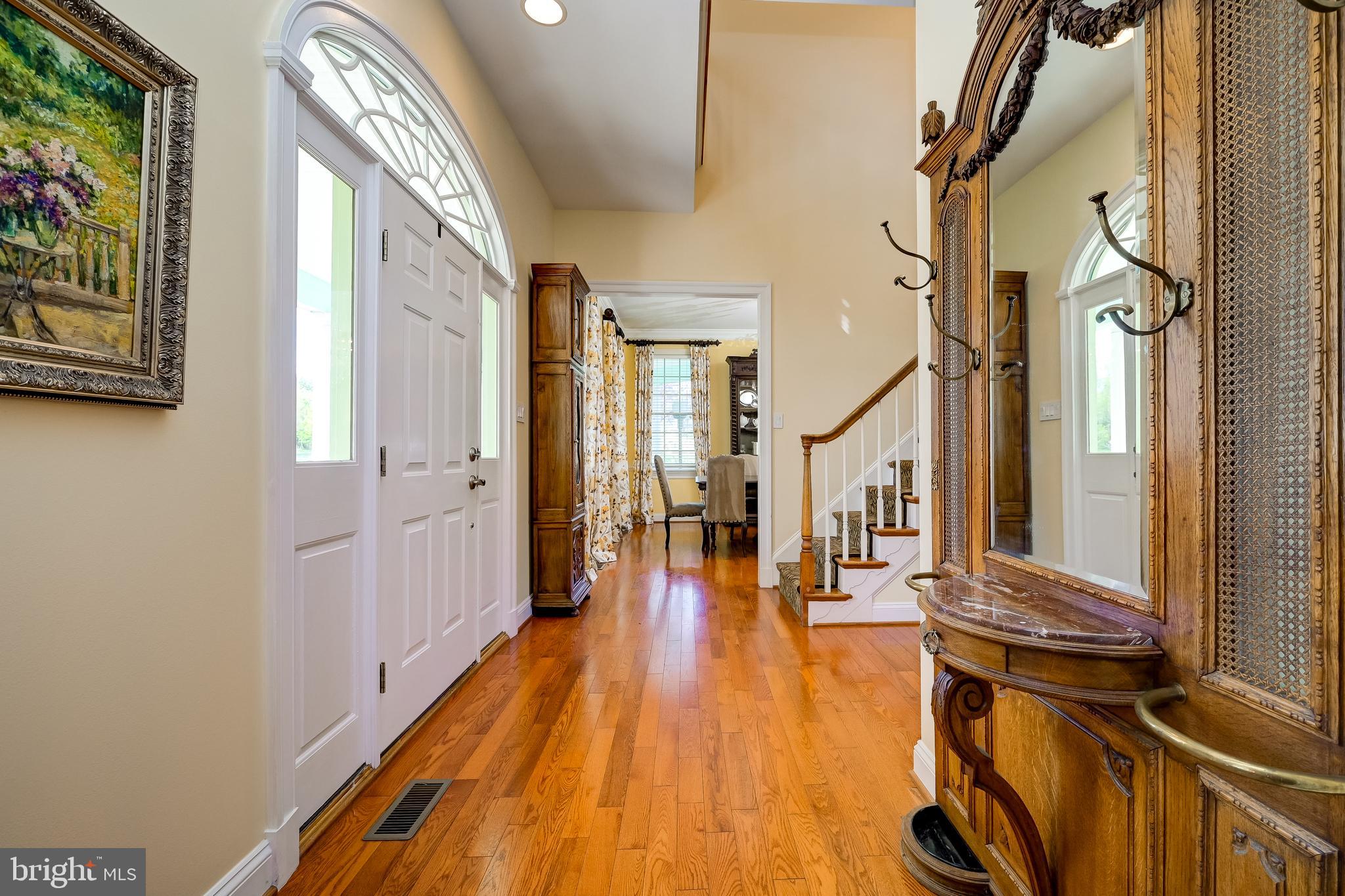 12850 Highland Road Highland, MD 20777 - Photo 10 of 56 a view of a hallway with wooden floor and staircase