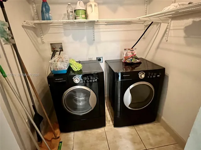 a kitchen with stainless steel appliances kitchen island granite countertop a refrigerator and a stove