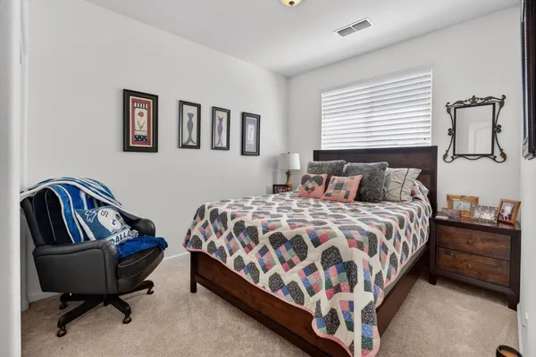 a bedroom with a bed and chair