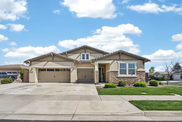a front view of a house with a garden