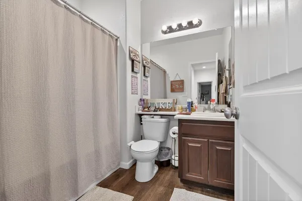 a bathroom with a toilet a sink and a mirror