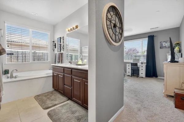 a bathroom with a bathtub sink and mirror