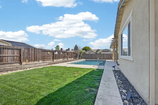a view of a swimming pool with a yard