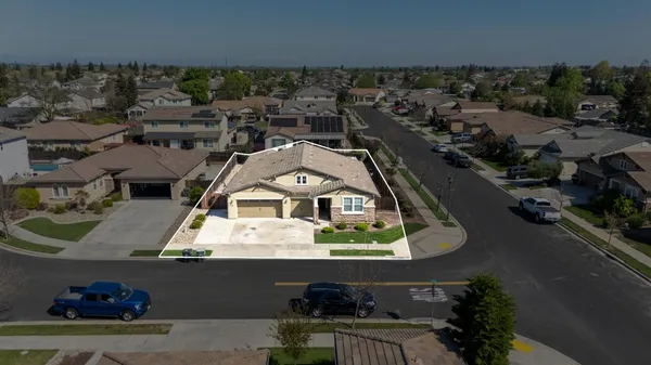 an aerial view of a house with a swimming pool