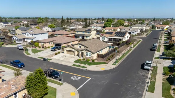 an aerial view of residential houses with outdoor space