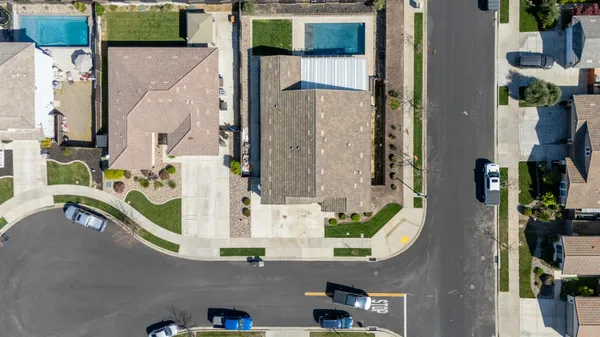 an aerial view of multi story residential apartment building with yard