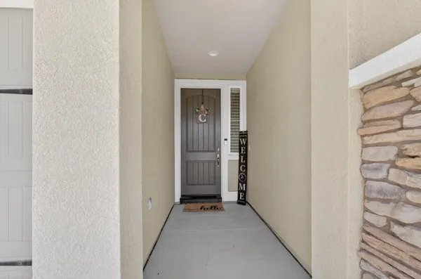 a view of a hallway with wooden floor and entryway